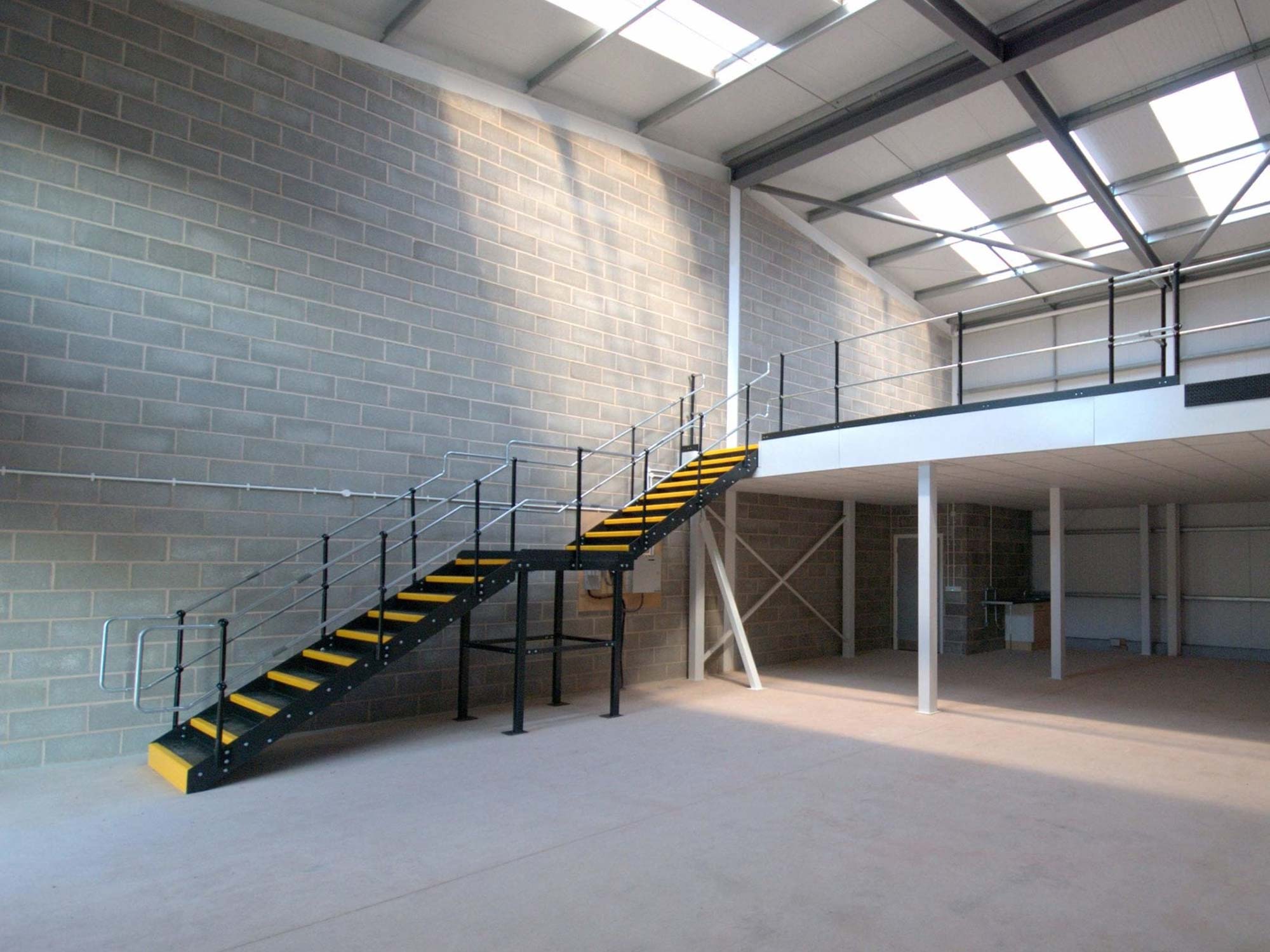 mezzanine floor with brick walls behind mezzanine floor with brick walls behind