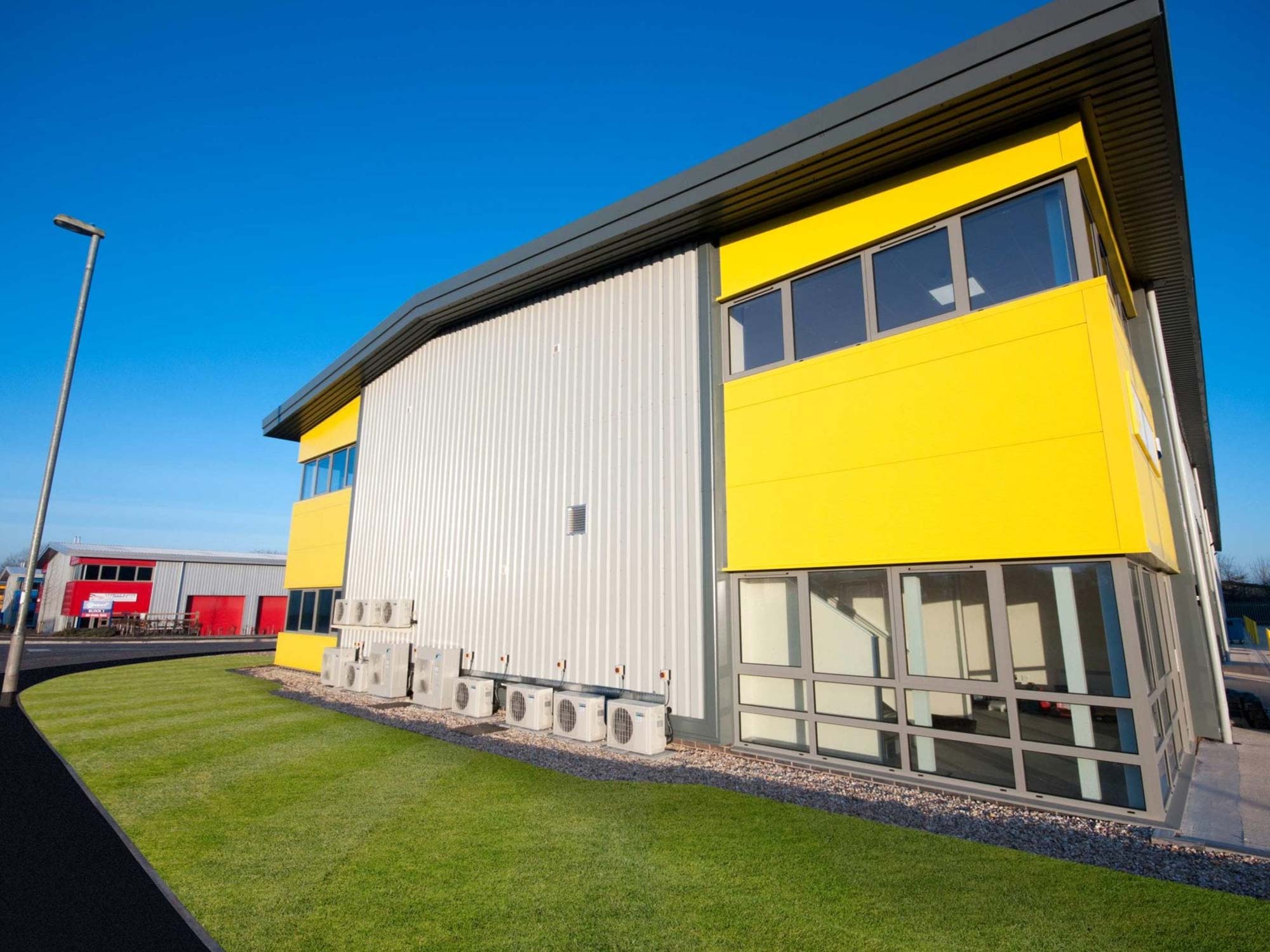 air conditioning systems in a row outside yellow building air conditioning systems in a row outside yellow building