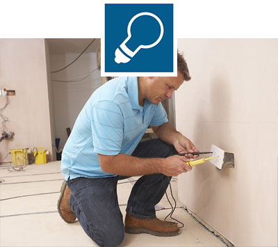 male electrician checking electrical connection inside wall male electrician checking electrical connection inside wall