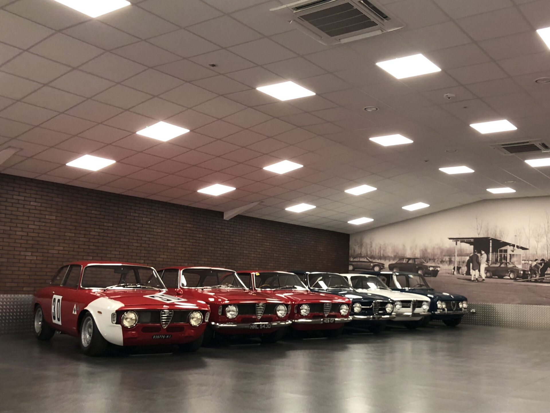 A row of classic cars displayed in a showroom