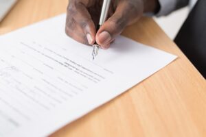 Person Writing On Paper With Fountain Pen