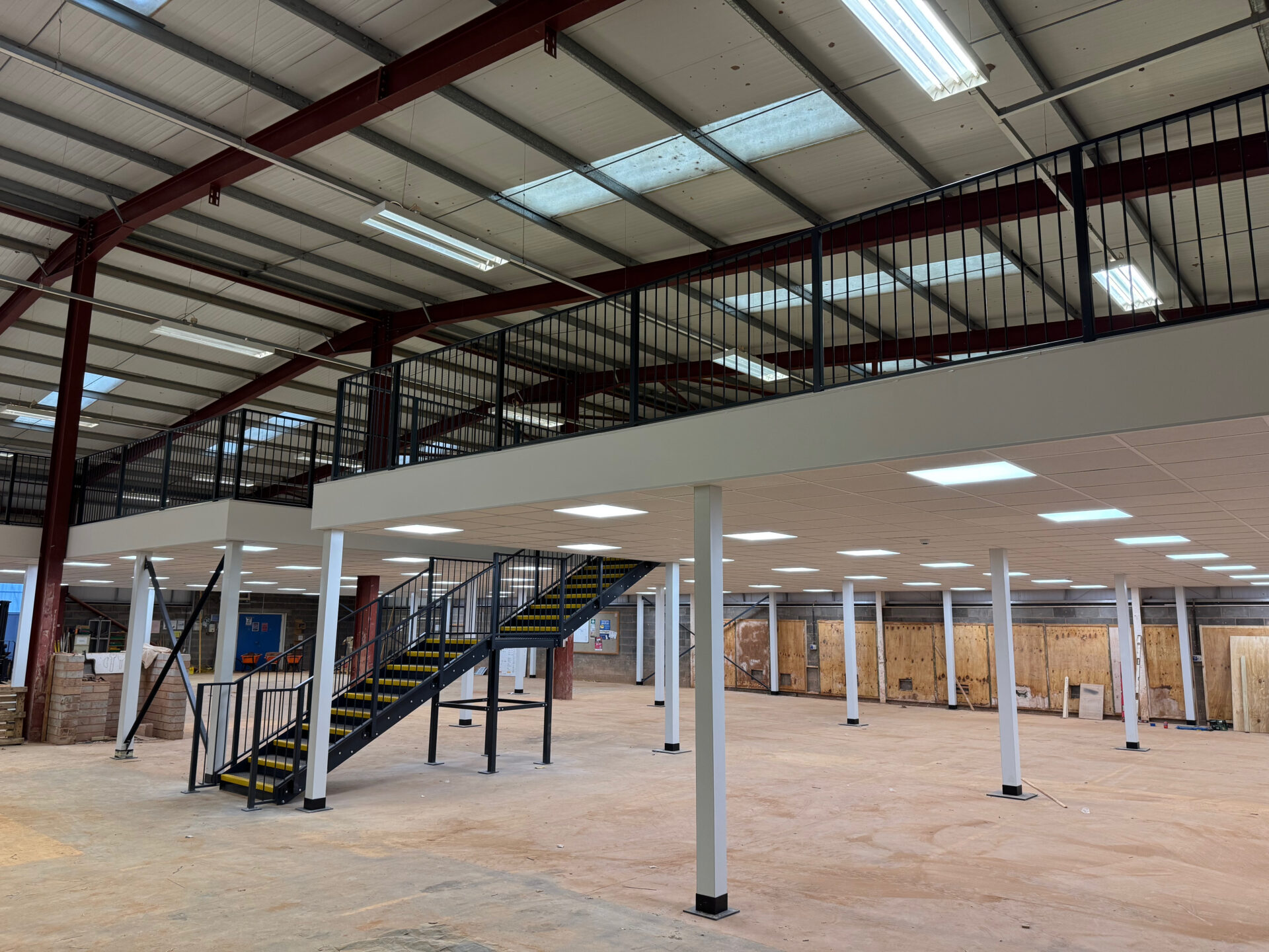 Suspended floor and stairs installed office mezzanine floors in London with windows